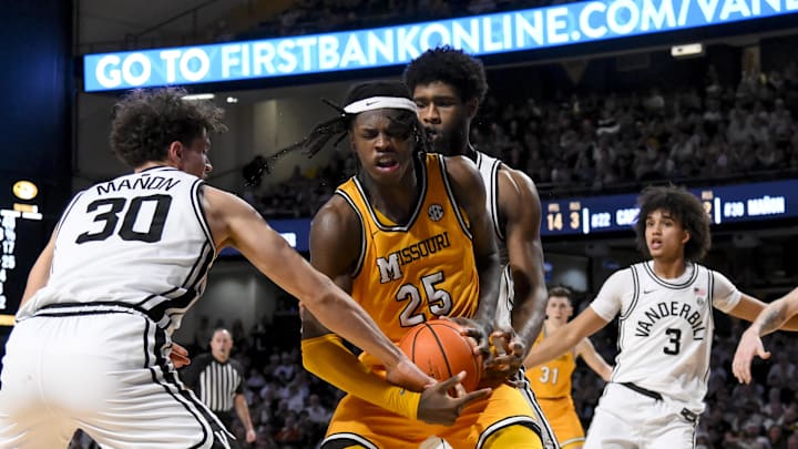 Mar 1, 2025; Nashville, Tennessee, USA;  Vanderbilt Commodores guard Chris Manon (30) strips Missouri Tigers guard Mark Mitchell (25) during the second half at Memorial Gymnasium. Mandatory Credit: Steve Roberts-Imagn Images