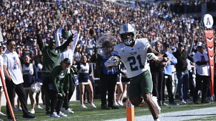Nov 16, 2024; Annapolis, Maryland, USA; Tulane Green Wave running back Makhi Hughes (21) scores a touchdown during the first half against the Navy Midshipmen at Navy-Marine Corps Memorial Stadium. Nov 16, 2024; Annapolis, Maryland, USA; Tulane Green Wave running back Makhi Hughes (21) scores a touchdown during the first half against the Navy Midshipmen at Navy-Marine Corps Memorial Stadium.