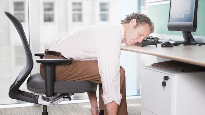 Businessman sleeping on computer keyboard Businessman sleeping on computer keyboard