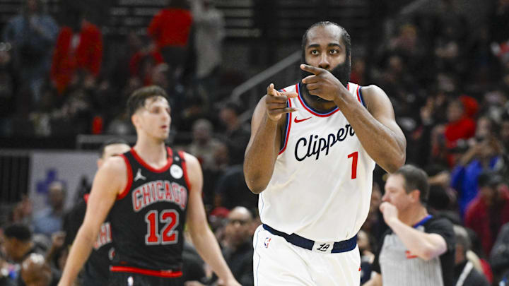 Feb 26, 2025; Chicago, Illinois, USA;  LA Clippers guard James Harden (1) points towards former Chicago Bulls player Pat Beverley, who was on the sidelines, after scoring against the Chicago Bulls during the second half at the United Center. Mandatory Credit: Matt Marton-Imagn Images