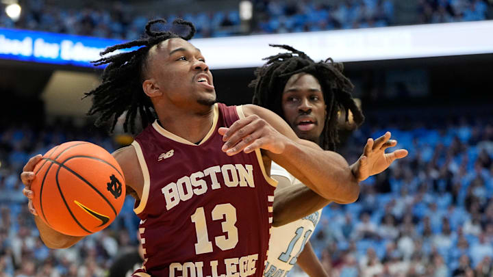 Jan 25, 2025; Chapel Hill, North Carolina, USA;  Boston College Eagles guard Donald Hand Jr. (13) with the ball as North Carolina Tar Heels guard Ian Jackson (11) defends in the first half at Dean E. Smith Center. Mandatory Credit: Bob Donnan-Imagn Images