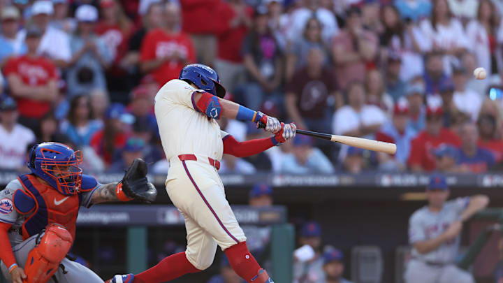 Oct 5, 2024; Philadelphia, PA, USA; Philadelphia Phillies designated hitter Kyle Schwarber (12) hits a solo home run against the New York Mets in the first inning in game one of the NLDS for the 2024 MLB Playoffs at Citizens Bank Park.