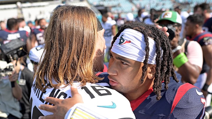 Sep 24, 2023; Jacksonville, Florida, USA; Houston Texans quarterback CJ Stroud (7) and Jacksonville Jaguars quarterback Trevor Lawrence (16) meet at the end of the game at EverBank Stadium. Mandatory Credit: Melina Myers-Imagn Images