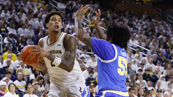 Feb 14, 2026; Ann Arbor, Michigan, USA; Michigan Wolverines forward Yaxel Lendeborg (23) is defended by UCLA Bruins guard Skyy Clark (55) in the first half at Crisler Center. Mandatory Credit: Rick Osentoski-Imagn Images