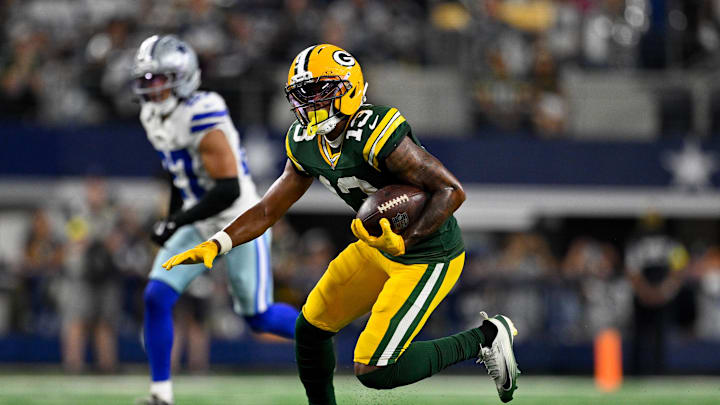 Sep 28, 2025; Arlington, Texas, USA; Green Bay Packers wide receiver Dontayvion Wicks (13) runs with the ball during the game between the Dallas Cowboys and the Green Bay Packers at AT&T Stadium. Mandatory Credit: Jerome Miron-Imagn Images