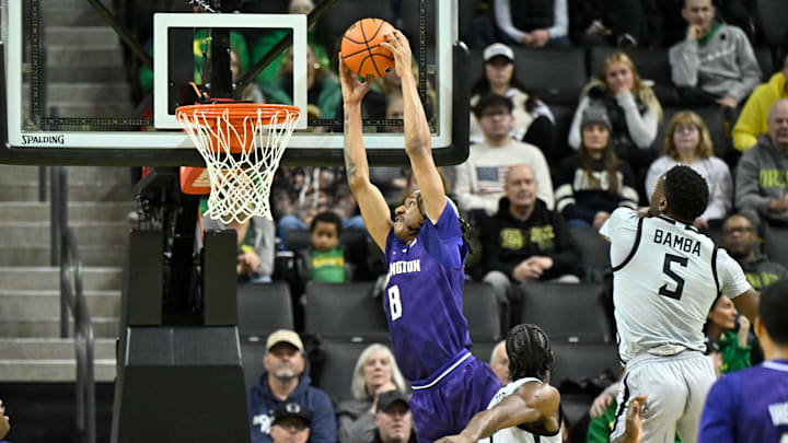 Huskies forward Tyler Harris goes for a dunk against Oregon in Eugene.