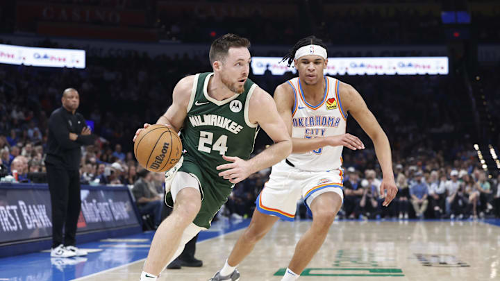 Feb 3, 2025; Oklahoma City, Oklahoma, USA; Milwaukee Bucks guard Pat Connaughton (24) drives around Oklahoma City Thunder forward Ousmane Dieng (13) during the second quarter at Paycom Center. Mandatory Credit: Alonzo Adams-Imagn Images
