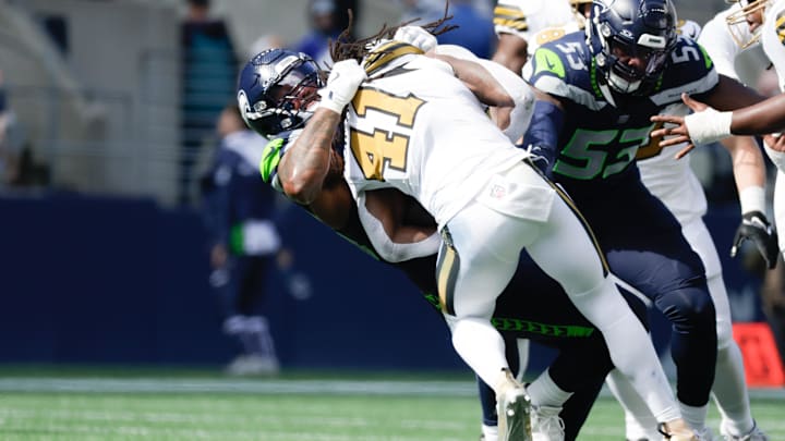 Seahawks defensive end Leonard Williams (99) tackles Saints running back Alvin Kamara (41) in Week 3.