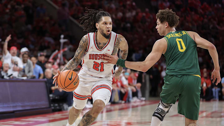 Mar 4, 2026; Houston, Texas, USA; Houston Cougars guard Emanuel Sharp (21) dribbles against Baylor Bears guard Dan Skillings Jr. (0) in the first half at Fertitta Center. Mandatory Credit: Thomas Shea-Imagn Images