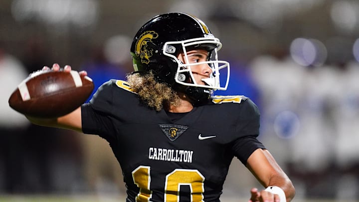 Oct 20, 2023; Carrollton, GA, USA; Carrollton Trojans quarterback Julian Lewis (10) drops back to pass against the Westlake Lions during the first half at Grisham Stadium. The 15-year-old Carrollton High student has already committed to playing for the University of Southern California Trojans and has been considered one of the top high school quarterback prospects. Mandatory Credit: John David Mercer-Imagn Images