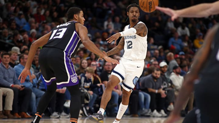 Memphis Grizzlies guard Ja Morant (12) passes the ball as Sacramento Kings forward Keegan Murray (13) defends during the second quarter at FedExForum. Mandatory Credit: Petre Thomas-Imagn Images