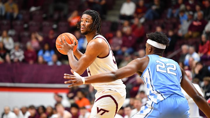 Mar 4, 2025; Blacksburg, Virginia, USA; Virginia Tech Hokies forward Mylyjael Poteat (34) looks to pass the ball asNorth Carolina Tar Heels forward Ven-Allen Lubin (22) defends during the first half at Cassell Coliseum. Mandatory Credit: Brian Bishop-Imagn Images