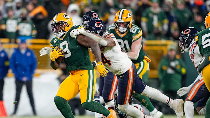 Dec 7, 2025; Green Bay, Wisconsin, USA; Green Bay Packers wide receiver Christian Watson (9) is tackled by Chicago Bears defensive lineman Austin Booker (94) in the fourth quarter at Lambeau Field. Mandatory Credit: Jeff Hanisch-Imagn Images Dec 7, 2025; Green Bay, Wisconsin, USA; Green Bay Packers wide receiver Christian Watson (9) is tackled by Chicago Bears defensive lineman Austin Booker (94) in the fourth quarter at Lambeau Field. Mandatory Credit: Jeff Hanisch-Imagn Images