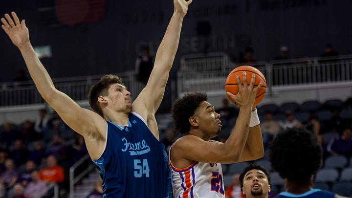 Evansville   s Kenny Strawbridge Jr. (20) takes a shot against Illinois Chicago's Cameron Fens (54) as the University of Evansville Purple Aces play the University of Illinois at Chicago Flames at Ford Center in Evansville, Ind., Wednesday, Feb. 22, 2023.

Mb Uevsuic 15