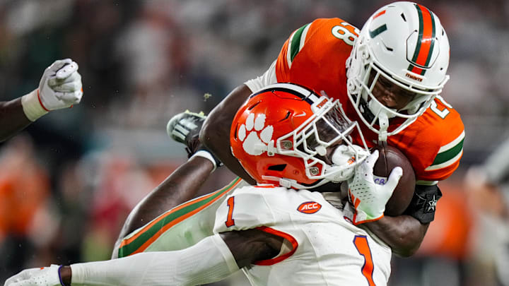 Oct 21, 2023; Miami Gardens, Florida, USA; Clemson Tigers safety Andrew Mukuba (1) tackles Miami Hurricanes running back Ajay Allen (28) during over time at Hard Rock Stadium. Mandatory Credit: Rich Storry-Imagn Images Oct 21, 2023; Miami Gardens, Florida, USA; Clemson Tigers safety Andrew Mukuba (1) tackles Miami Hurricanes running back Ajay Allen (28) during over time at Hard Rock Stadium. Mandatory Credit: Rich Storry-Imagn Images