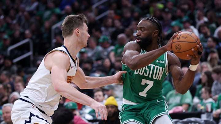 Mar 2, 2025; Boston, Massachusetts, USA; Boston Celtics forward Jaylen Brown (7) defended by Denver Nuggets forward Christian Braun (0) during the second half at TD Garden. Mandatory Credit: Paul Rutherford-Imagn Images