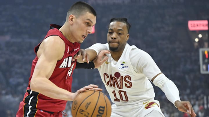 Apr 20, 2025; Cleveland, Ohio, USA; Miami Heat guard Tyler Herro (14) drives against Cleveland Cavaliers guard Darius Garland (10) in the first quarter at Rocket Arena. Mandatory Credit: David Richard-Imagn Images