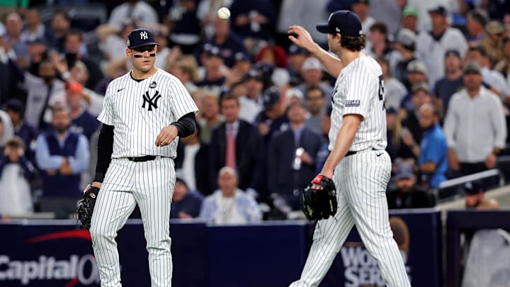 Oct 30, 2024; New York, New York, USA; New York Yankees first baseman Anthony Rizzo (48) talks with pitcher Gerrit Cole (45) after Cole didn’t cover first base allowing a base hit during the fifth inning against the Los Angeles Dodgers in game four of the 2024 MLB World Series at Yankee Stadium. Mandatory Credit: Brad Penner-Imagn Images