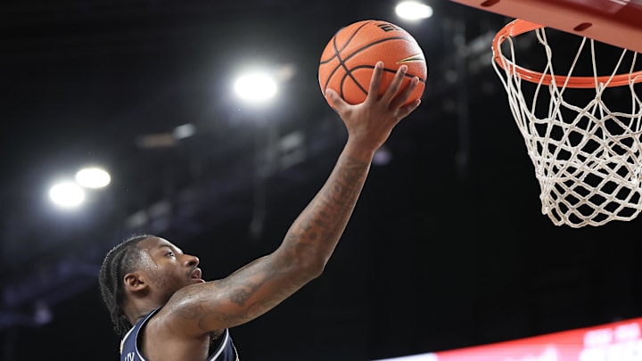 Feb 21, 2026; Houston, Texas, USA;  Arizona Wildcats guard Jaden Bradley (0) scores against the Houston Cougars in the first half at Fertitta Center. Mandatory Credit: Thomas Shea-Imagn Images