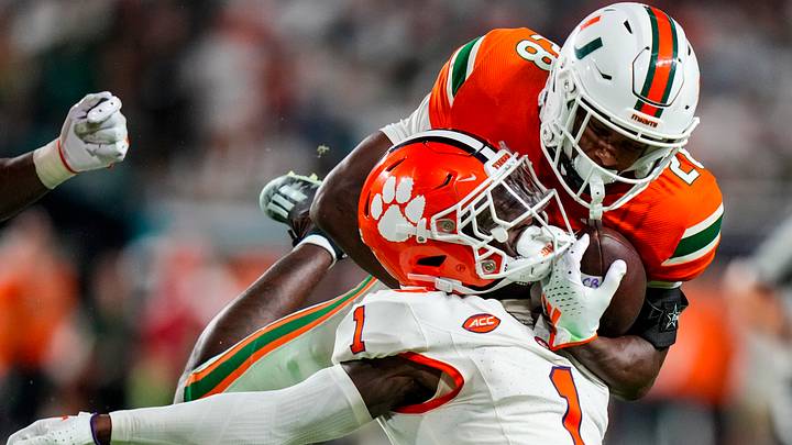 Oct 21, 2023; Miami Gardens, Florida, USA; Clemson Tigers safety Andrew Mukuba (1) tackles Miami Hurricanes running back Ajay Allen (28) during over time at Hard Rock Stadium. Mandatory Credit: Rich Storry-USA TODAY Sports
