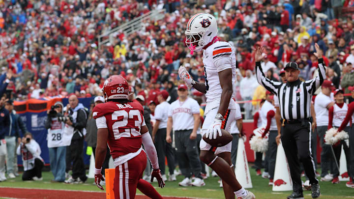 Oct 25, 2025; Fayetteville, Arkansas, USA; Auburn Tigers wide receiver Cam Coleman (8) celebrates after scoring a touchdown defended by Arkansas Razorbacks defensive back Julian Neal (23) during the first quarter at Donald W. Reynolds Razorback Stadium. Mandatory Credit: Nelson Chenault-Imagn Images Oct 25, 2025; Fayetteville, Arkansas, USA; Auburn Tigers wide receiver Cam Coleman (8) celebrates after scoring a touchdown defended by Arkansas Razorbacks defensive back Julian Neal (23) during the first quarter at Donald W. Reynolds Razorback Stadium. Mandatory Credit: Nelson Chenault-Imagn Images