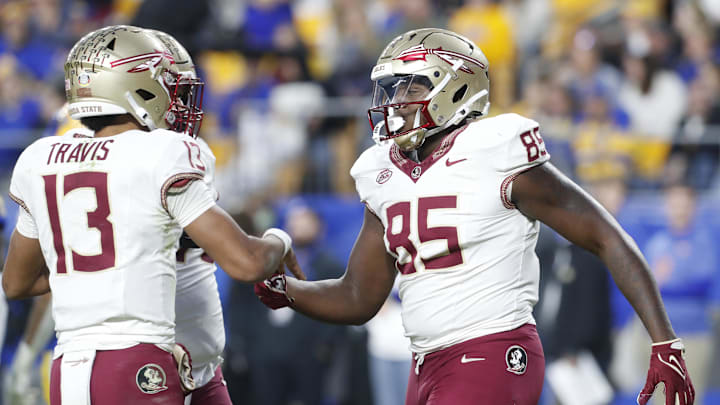 Nov 4, 2023; Pittsburgh, Pennsylvania, USA;  Florida State Seminoles quarterback Jordan Travis (13) and tight end Markeston Douglas (85) celebrate after combining for a touchdown against the Pittsburgh Panthers during the third quarter at Acrisure Stadium. The Seminoles won 24-7Mandatory Credit: Charles LeClaire-Imagn Images