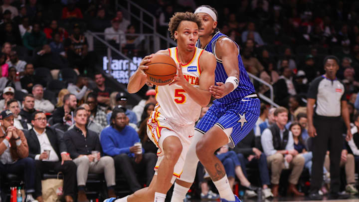 Nov 4, 2025; Atlanta, Georgia, USA; Atlanta Hawks guard Dyson Daniels (5) drives past Orlando Magic forward Paolo Banchero (5) in the third quarter at State Farm Arena. Mandatory Credit: Brett Davis-Imagn Images
