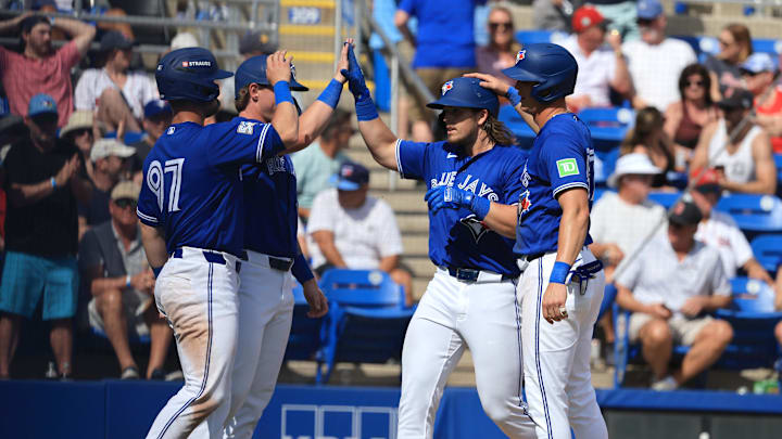 Mar 2, 2026; Dunedin, Florida, USA;Toronto Blue Jays third baseman Addison Barger (47) is congratulated by third baseman Riley Tirotta (87) and teammates after he hit a grand slam during the fifth inning against the Boston Red Sox at TD Ballpark. Mandatory Credit: Kim Klement Neitzel-Imagn Images
