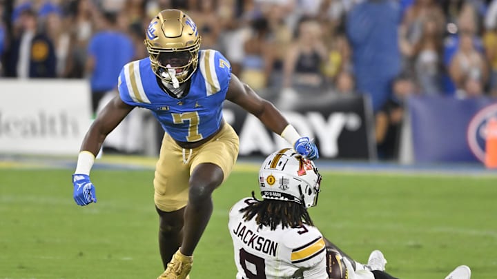 Oct 12, 2024; Pasadena, California, USA; UCLA Bruins defensive back K.J. Wallace (7) celebrates after making a stop against Minnesota Golden Gophers wide receiver Daniel Jackson (9) in the first quarter at Rose Bowl. Mandatory Credit: Robert Hanashiro-Imagn Images