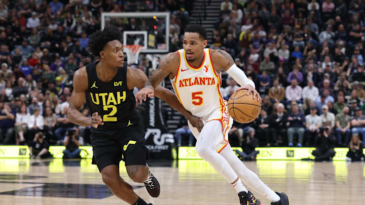 Mar 15, 2024; Salt Lake City, Utah, USA; Atlanta Hawks guard Dejounte Murray (5) drives against Utah Jazz guard Collin Sexton (2) during the second quarter at Delta Center. Mandatory Credit: Rob Gray-Imagn Images