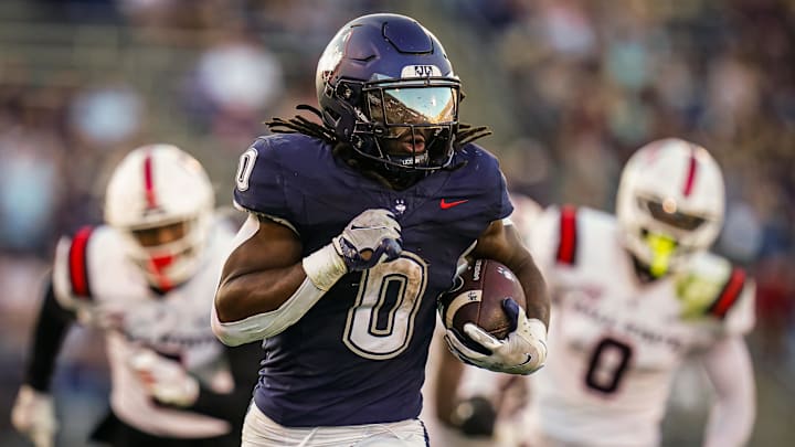 Sep 20, 2025; East Hartford, Connecticut, USA; Connecticut Huskies running back Cam Edwards (0) runs the ball for a touchdown against et Ball State Cardinals in the second half at Pratt & Whitney Stadium at Rentschler Field. Mandatory Credit: David Butler II-Imagn Images