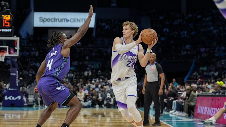 Nov 2, 2025; Charlotte, North Carolina, USA; Utah Jazz forward Lauri Markkanen (23) looks to pass pressured by Charlotte Hornets guard Sion James (4) during the second half at Spectrum Center. Mandatory Credit: Jim Dedmon-Imagn Images