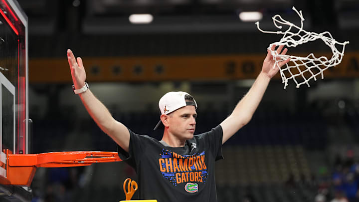 Apr 7, 2025; San Antonio, TX, USA;  Florida Gators head coach Todd Golden cuts down the net after defeating the Houston Cougars in the national championship game of the Final Four of the 2025 NCAA Tournament at the Alamodome. Mandatory Credit: Robert Deutsch-Imagn Images