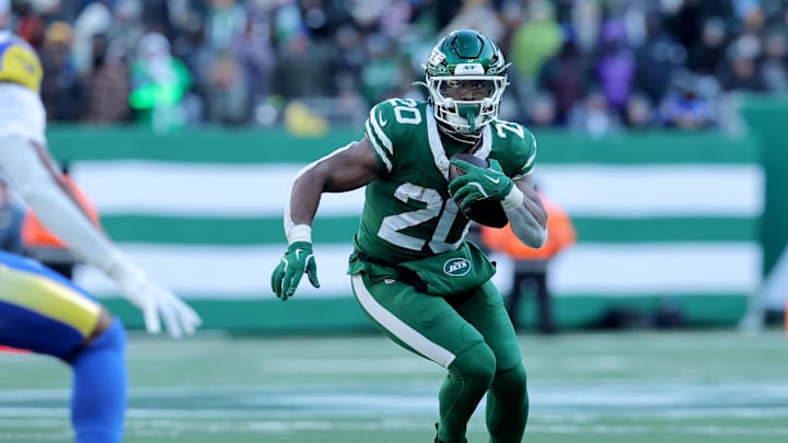Dec 22, 2024; East Rutherford, New Jersey, USA; New York Jets running back Breece Hall (20) runs with the ball against the Los Angeles Rams during the second quarter at MetLife Stadium. Mandatory Credit: Brad Penner-Imagn Images