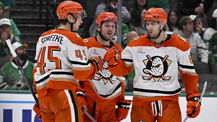 Nov 6, 2025; Dallas, Texas, USA; Anaheim Ducks right wing Beckett Sennecke (45) and center Mason McTavish (23) and left wing Cutter Gauthier (61) celebrates an empty net goal scored by McTavish against the Dallas Stars during the third period at the American Airlines Center. Mandatory Credit: Jerome Miron-Imagn Images