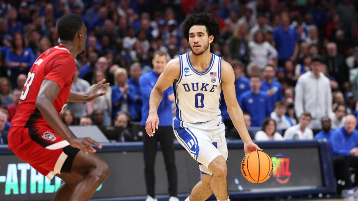 Mar 31, 2024; Dallas, TX, USA; Duke Blue Devils guard Jared McCain (0) controls the ball against North Carolina State Wolfpack forward Mohamed Diarra (23) in the first half in the finals of the South Regional of the 2024 NCAA Tournament at American Airline Center. Mandatory Credit: Kevin Jairaj-USA TODAY Sports