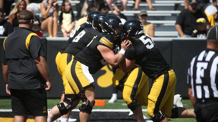 Iowa’s Logan Jones (65) left, and Kade Pieper (58) run a drill with the offensive line during Kids Day at Kinnick Saturday, Aug. 10, 2024 at Kinnick Stadium in Iowa City, Iowa.