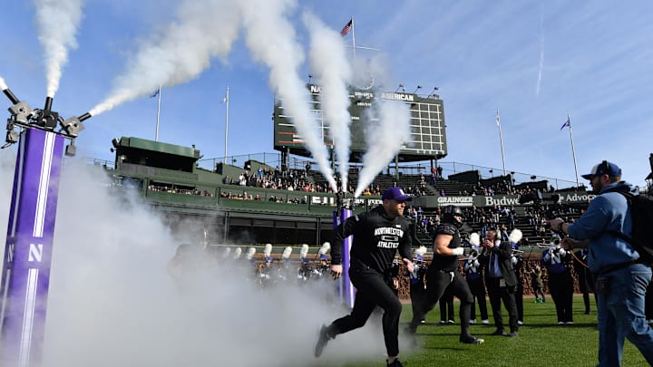 The Northwestern Wildcats head coach enter the field