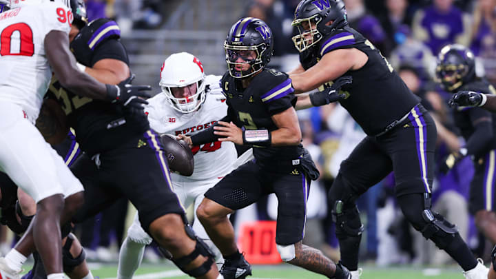 Oct 10, 2025; Seattle, Washington, USA; Washington Huskies quarterback Demond Williams Jr. (2) is pressured by Rutgers Scarlet Knights defensive lineman Eric O'Neill (99)  at Husky Stadium. Mandatory Credit: Kevin Ng-Imagn Images