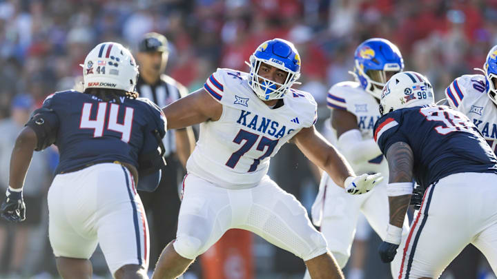 Nov 8, 2025; Tucson, Arizona, USA; Kansas Jayhawks offensive lineman Enrique Cruz Jr. (77) against the Arizona Wildcats at Arizona Stadium. Mandatory Credit: Mark J. Rebilas-Imagn Images