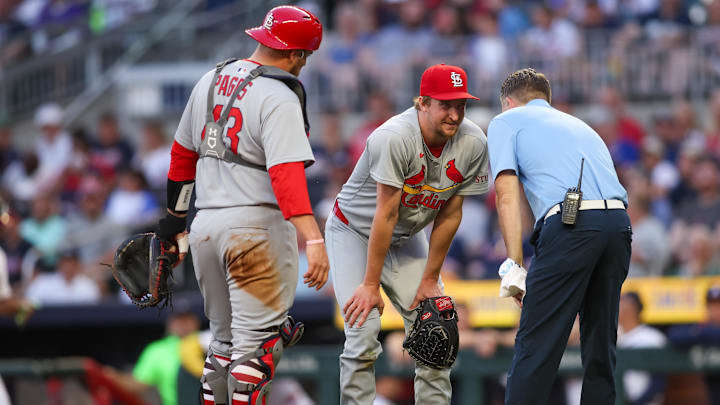 Apr 21, 2025; Atlanta, Georgia, USA; St. Louis Cardinals starting pitcher Erick Fedde (12) reacts after being hit by a ball against the Atlanta Braves in the second inning at Truist Park. Mandatory Credit: Brett Davis-Imagn Images Apr 21, 2025; Atlanta, Georgia, USA; St. Louis Cardinals starting pitcher Erick Fedde (12) reacts after being hit by a ball against the Atlanta Braves in the second inning at Truist Park. Mandatory Credit: Brett Davis-Imagn Images