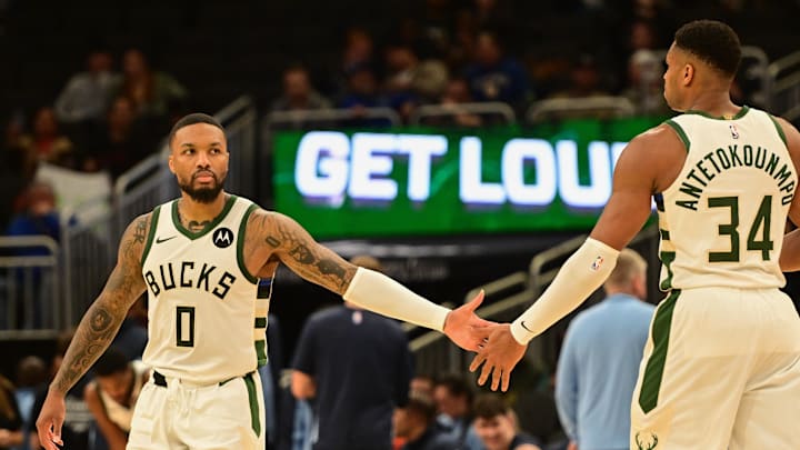 Oct 20, 2023; Milwaukee, Wisconsin, USA; Milwaukee Bucks guard Damian Lillard (0) greets forward Giannis Antetokounmpo (34) during game against the Memphis Grizzlies at Fiserv Forum. Mandatory Credit: Benny Sieu-Imagn Images