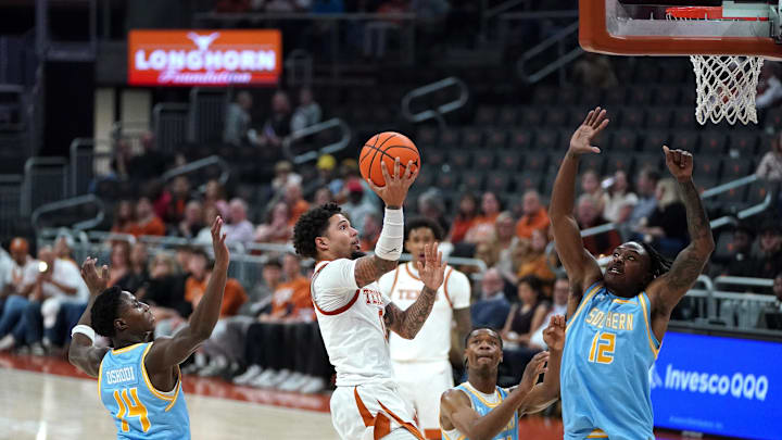 Texas Longhorns guard Jordan Pope drives the ball to the basket against Southern University Jaguars forward AJ Barnes and guard Fazl Oshodi during the second half at Moody Center. Texas Longhorns guard Jordan Pope drives the ball to the basket against Southern University Jaguars forward AJ Barnes and guard Fazl Oshodi during the second half at Moody Center.