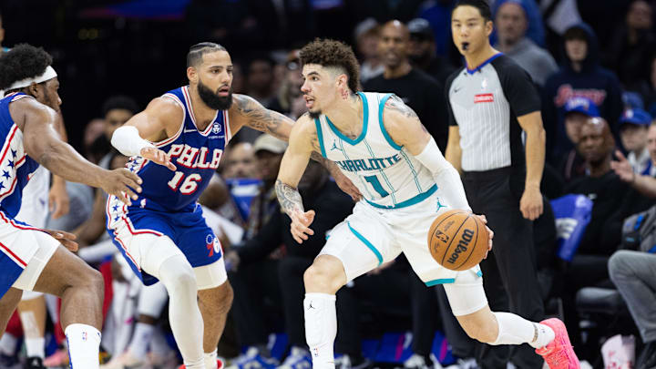 Nov 10, 2024; Philadelphia, Pennsylvania, USA; Charlotte Hornets guard LaMelo Ball (1) dribbles the ball against Philadelphia 76ers forward Caleb Martin (16) during the fourth quarter at Wells Fargo Center. Mandatory Credit: Bill Streicher-Imagn Images