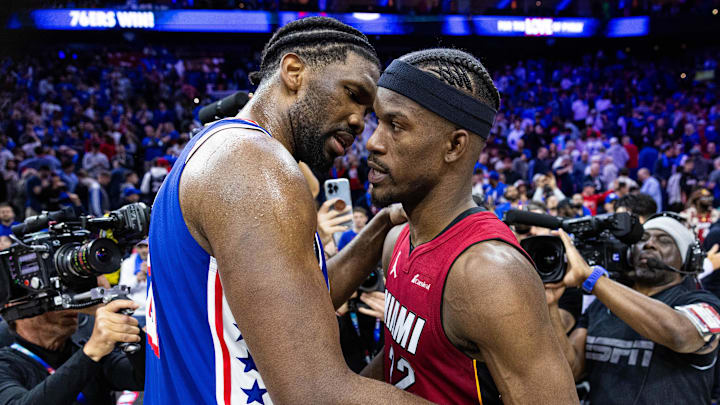 Apr 17, 2024; Philadelphia, Pennsylvania, USA; Philadelphia 76ers center Joel Embiid (21) hugs Miami Heat forward Jimmy Butler.