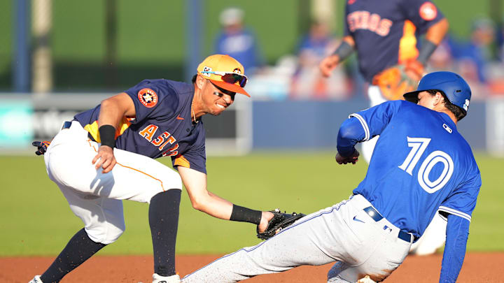 Toronto Blue Jays outfielder Joey Loperfido (10) is  tagged out trying to steal second base by Houston Astros shortstop Mauricio Dubón (14) in the first inning at CACTI Park of the Palm Beaches on March 14.