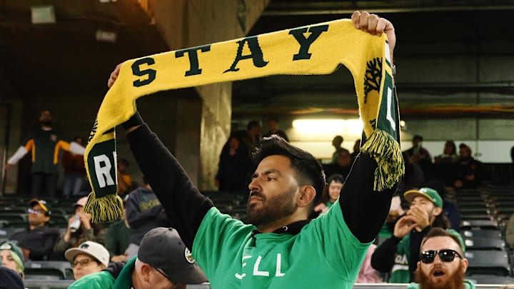 Apr 28, 2023; Oakland, California, USA; An Oakland Athletics fan holds a scarf during the sixth inning against the Cincinnati Reds at Oakland Coliseum. Mandatory Credit: Kelley L Cox-Imagn Images