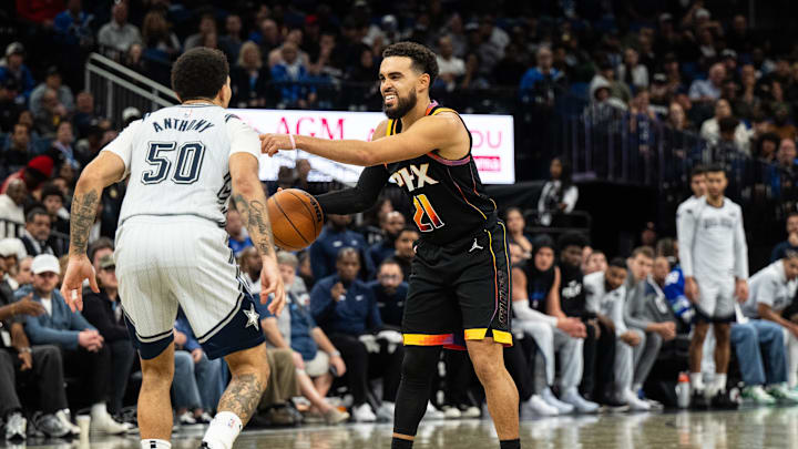 Dec 8, 2024; Orlando, Florida, USA; Phoenix Suns guard Tyus Jones (21) dribbles the ball against Orlando Magic guard Cole Anthony (50) in the fourth quarter at Kia Center. Mandatory Credit: Jeremy Reper-Imagn Images Dec 8, 2024; Orlando, Florida, USA; Phoenix Suns guard Tyus Jones (21) dribbles the ball against Orlando Magic guard Cole Anthony (50) in the fourth quarter at Kia Center. Mandatory Credit: Jeremy Reper-Imagn Images