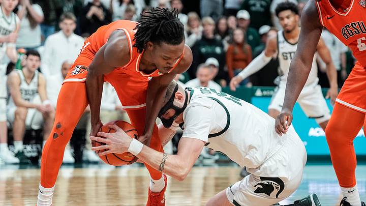 Nov 16, 2024; East Lansing, Michigan, USA; Bowling Green Falcons guard Javontae Campbell (2) and Michigan State Spartans center Carson Cooper (15) battle for the ball during the second half at Breslin Center. Mandatory Credit: Junfu Han/USA TODAY Network via Imagn Images