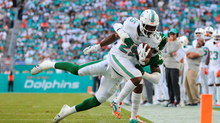 Miami Dolphins running back Jaylen Wright (25) runs with the football against New York Jets linebacker Jamien Sherwood (44) during the second quarter at Hard Rock Stadium.